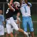 Dexter senior Jacob VanHoof and  Skyline senior Jordan Woods reach for a pass in the end zone during the first half at Dexter on Friday night.
